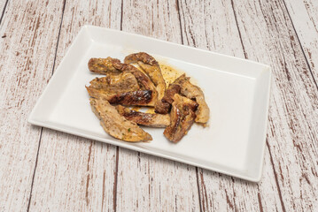 Grilled acorn-fed Iberian pork secret with its characteristic vein of infiltrated fat, juicy on the inside and crispy on the outside, accompanied by piquillo peppers
