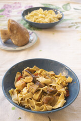 handmade pappardelle pasta with porcini mushrooms in blue bowl