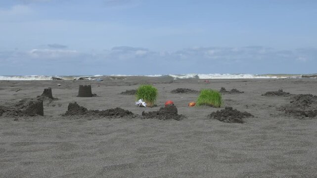 Traditional Sabzeh sprouts and apples placed on a sandy beach by the sea, part of the Iranian Sizdah Bedar ritual during Nowruz, symbolizing renewal, letting go, and returning life to nature.