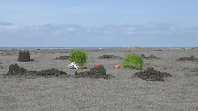 Traditional Sabzeh sprouts and apples placed on a sandy beach by the sea, part of the Iranian Sizdah Bedar ritual during Nowruz, symbolizing renewal, letting go, and returning life to nature.