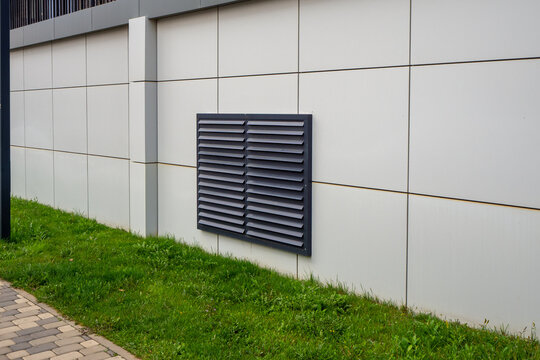 Ventilation grille on exterior wall of modern building with clean geometric composition and neutral colors. For ventilation systems, building engineering, HVAC, architecture, facade design. Photo