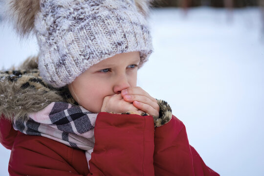 Frozen Child Freezing Shivering in Cold Winter Background Outdoor. Frozen Kid in Winter Clothes in Cold  Weather.