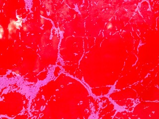 Abstract red and pink marble texture background with white veins and patterns