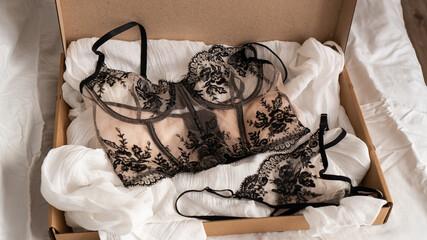 Women's set of erotic and beautiful underwear in a box. Beige bra and thong with black lace. Elegant gift © drk.muse