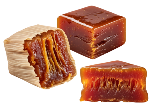 Three pieces of quince paste, one wrapped in corn husk, isolated on transparent background - Powered by Adobe