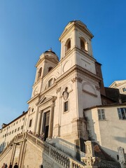 Fototapeta premium Rome, Italy - July 24, 2025, architectural detail of the Church of the Santissima Trinità dei Monti, in Piazza della Trinità dei Monti, a Catholic place of worship in Rome's Campo Marzio.