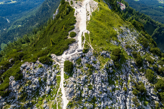 Aerial view of the Watzmann mountain peak, where the rugged terrain meets the sky, a tapestry of green vegetation and rocky outcrops, Berchtesgaden, Bayern, Germany.