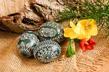 Easter, spring holiday - beautiful colorful Easter eggs, Czech home tradition of decorating with wax,
still life with Easter eggs and spring flowers,