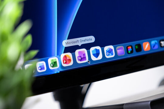 Poznan, Poland - October 16, 2025: Microsoft OneNote app icon with cursor hovering on screen dock, highlighting digital organization, note-taking, and efficient workflow