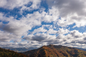 Panoramic view of autumn Carpathian mountains under cloudy sky