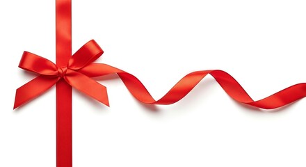 Elegant crimson ribbon with delicate bow cascading on a pristine white surface backdrop