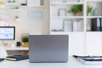 Modern workspace with laptop on desk in bright home office. Concept of remote work, and productivity