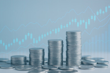 Money coins arranged in piles with digital financial data graphs representing profit accumulation and economic success