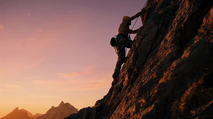 A man climbs a steep mountain at sunrise, symbolizing perseverance and courage.