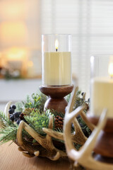 Beautiful LED candles and festive decor on wooden table indoors, closeup