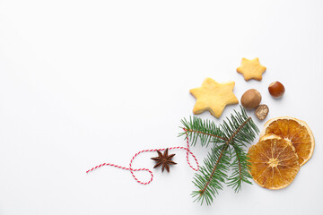 Christmas composition with fir tree branches, cookies and spices on white background, flat lay. Space for text