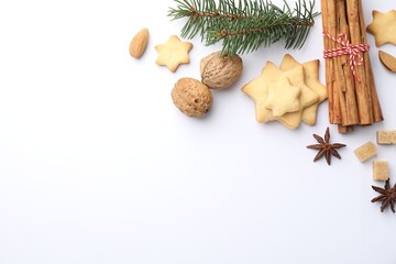 Christmas composition with fir tree branches, cookies and spices on white background, flat lay. Space for text