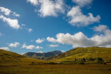 Golden valley and green hills beneath Snowdon peaks, Snowdonia, Wales