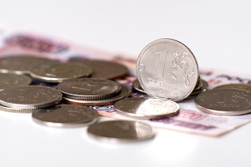 A closeup of assorted coins artfully scattered over banknotes, showcasing rich currency details vividly.