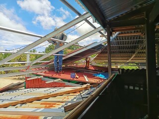 Man building house roof structure