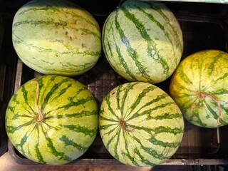 pile of watermelon in a market stall
