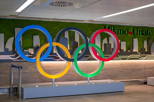 Olympic five rings Milano Linate, symbol global sport, for Milan Winter Games 2026, Italy awaits, vibrant welcome, travel hub, global unity through sport, Milan, Italy