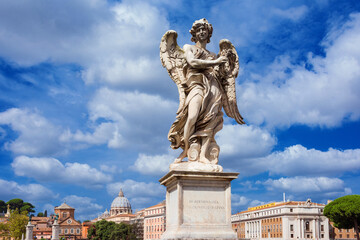 Angel statue holding the Crown of Thorns among clouds. A 17th century baroque masterpiece with the famous St Peter's Dome in the background