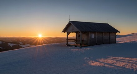 Wooden cabin at sunrise on a snowy mountain peak