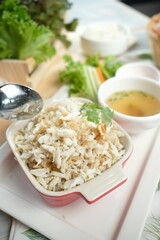 Close-up of a delicious crab meat dish served with soup and vegetables