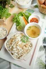 A culinary delight of crab meat, rice, fresh vegetables, soup and eggs arranged artistically on a table