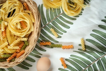 Close-up shot of an array of pasta and an egg, presenting a vibrant and appetizing composition....