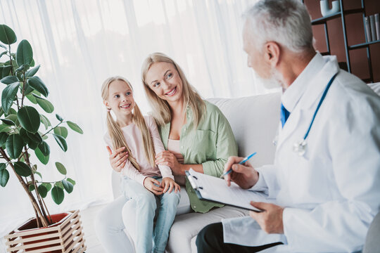Heartwarming family visit at the doctor office a mother and daughter with a friendly physician and warm smiles - Powered by Adobe