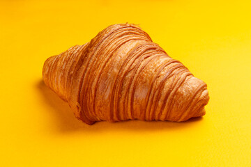 Croissant on a yellow background.