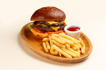 A delicious cheeseburger with fries and sauce.