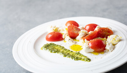 Cherry tomato salad with cheese on a plate