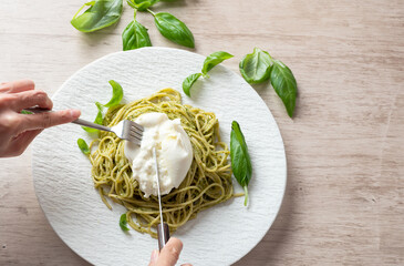 Basil pasta with burrata cheese on a plate