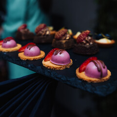 Elegant gourmet desserts on a slate tray