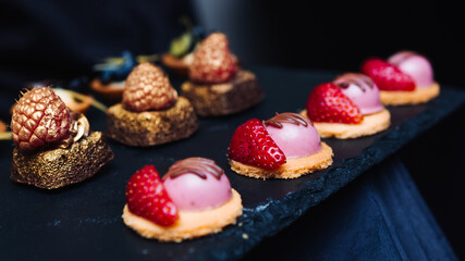 Elegant gourmet desserts on a slate tray