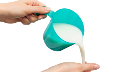 A hand pouring milk from a blue measuring cup onto another hand, isolated on transparent background