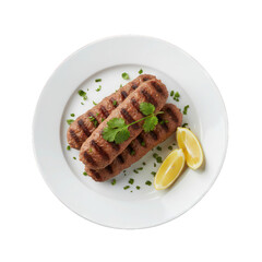 Grilled ground meat kebabs served on white plate with lemon wedges and garnish  ready to eat