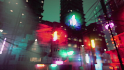 Colorful neon lights illuminate a lively urban scene at night. The glowing hues reflect off tall buildings, creating a vibrant atmosphere. People walk below, adding dynamic energy to the setting.