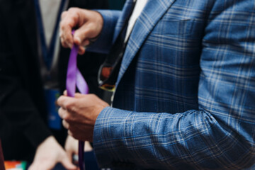 Process of checking in on conference congress forum event, registration desk table, visitors and attendees receiving lanyard with name badge and entry wristband bracelet and register electronic ticket
