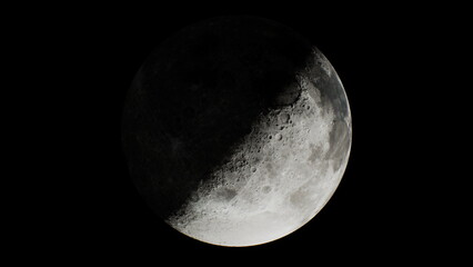 A stunning crescent moon shines brightly in the night sky, casting gentle light. The surface features are visible, showcasing craters and shadows that add depth and wonder.