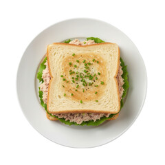 Elevated view of a classic tuna salad sandwich on a white plate against black backdrop