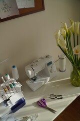 Sewing Workspace with Machine, Overlock and Flowers