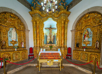 The ornate, gilded interior of a historic chapel