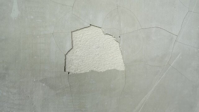 Repairing Damaged Wall Close Up of Cracks, Exposed Texture, and Surface Wear Indicating Need for Restoration and Attention to Interior Aesthetics