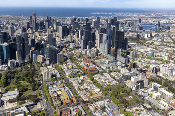 Aerial view of the city's skyscrapers contrasting with the leafy suburbs, a tapestry of urban life meeting nature's edge, Melbourne, Victoria, Australia.