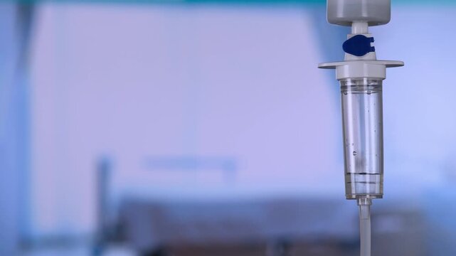 Dripping saline, Dripping medical perfusion close up equipment in clinic background, Medical equipment, Saline Solution IV Drip Fluid for Infusion in Hospital. Intravenous drip in operation room.