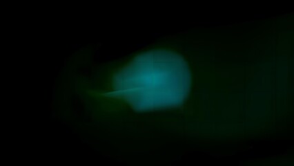 Mysterious dark abstract background with subtle teal and green blurred light leak or lens flare effect on black